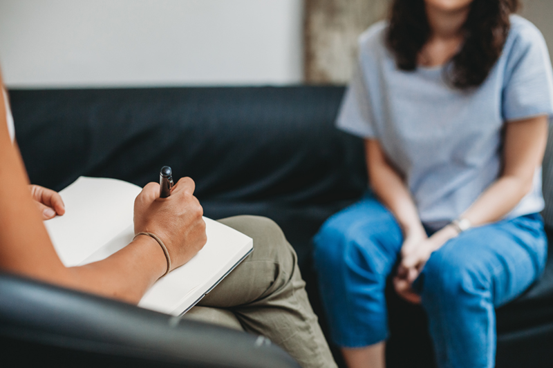Psychotherapy session, woman talking to his psychologist in the